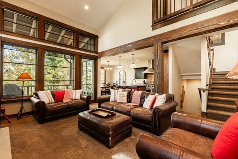 Vaulted great room with cozy red accents and large windows