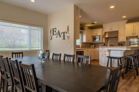 Kitchen - Dining table leading into the full, open kitchen area