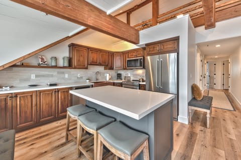 Penthouse Side A Renovated Fully Equipped Kitchen with Quartz Counters, Stainless Steel Appliances, and Hardwood Floors Throughout