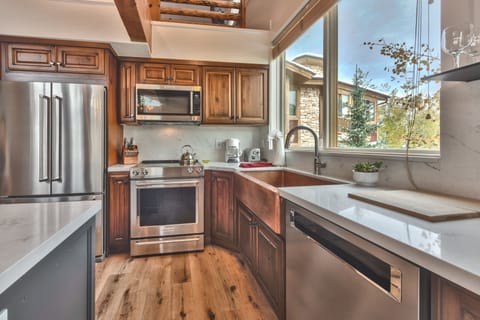 Renovated Fully Equipped Kitchen with Quartz Counters, Stainless Steel Appliances, and Hardwood Floors Throughout