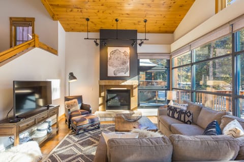 Cozy up in your mountain retreat with exposed wood beams, crackling fireplace, and plush sectional sofa perfect for movie nights.