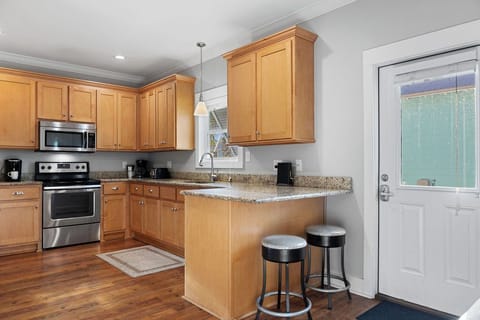 Kitchen - The open kitchen features stainless appliances and is fully stocked with all items needed for planning and preparing meals. Just bring the groceries!