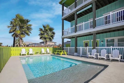 Private Pool — White Adirondack Chairs, Lime Green Fence & Teal Three-Story Beach House