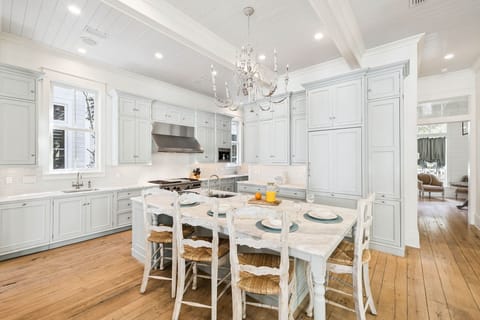 Your gourmet kitchen awaits with marble counters, professional appliances, and elegant chandelier lighting for memorable meal prep.