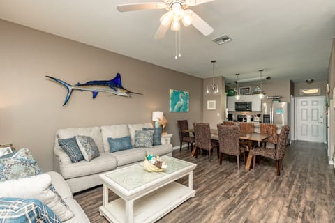 Your coastal-themed living space features comfortable seating and ocean-inspired decor, perfect for relaxing after beach adventures.