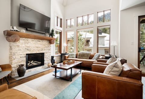 Cozy up by the fireplace in this stylish, open-concept living room