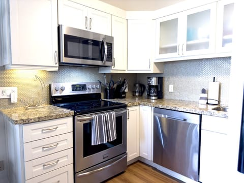 Beautiful and fully remodeled kitchen with granite counters, stainless steel appliances, and gorgeous touches.  Fully stocked for all your food preparation needs.