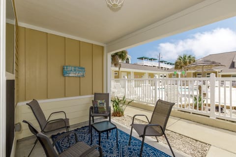 Step onto your private patio where comfortable seating and ocean-inspired decor create the perfect spot for morning coffee or evening relaxation.