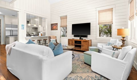 Plush seating, modern entertainment, and seamless kitchen views are waiting.