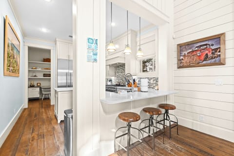 Your modern farmhouse kitchen features white cabinetry, granite counters, and a breakfast bar perfect for morning coffee.