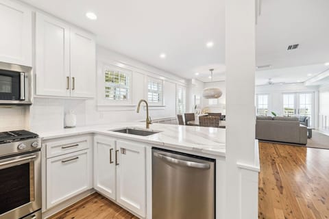 Your bright, modern kitchen features gleaming quartz countertops and stainless steel appliances, perfect for preparing meals during your stay.