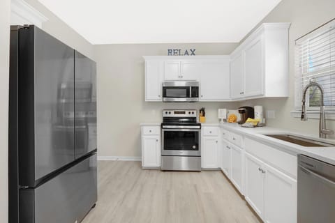 Kitchen - This recently updated kitchen features stainless appliances which include a dishwasher, built in microwave, electric oven with smooth cooktop, and refrigerator with ice maker.