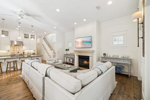 Sink into plush seating by the warm fireplace while enjoying your open-concept space that flows seamlessly from kitchen to living area.