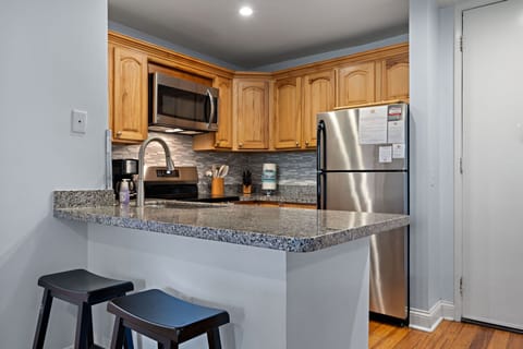 The kitchen boasts updated granite countertops and stainless steel appliances