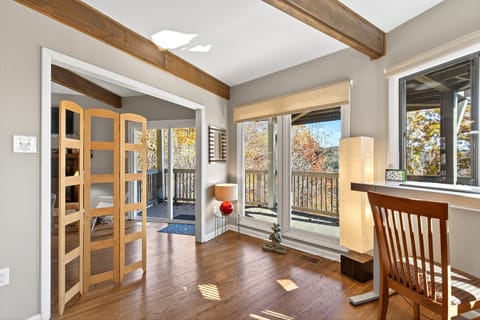 Middle-level den with deck access and a dedicated work station.