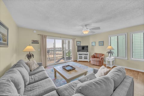 Sink into the plush sofas and unwind in your coastal-inspired living room, where bright natural light and beachy decor create the perfect atmosphere for relaxation.