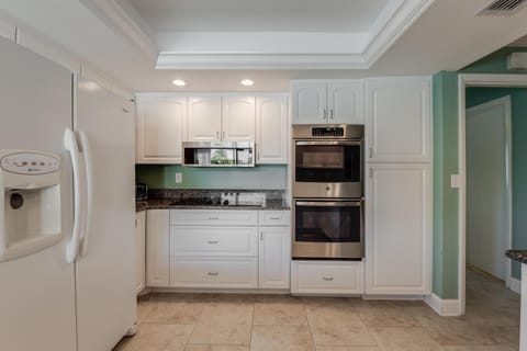 Feel the cool touch of marble countertops as you prepare meals surrounded by thoughtful details designed for effortless cooking and shared moments.