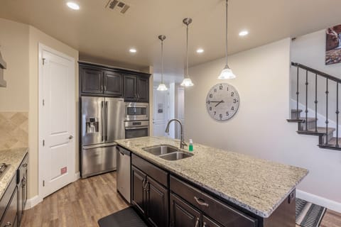 Kitchen Island - Side view of kitchen showing off the beautiful counter tops and stainless-steel appliances.