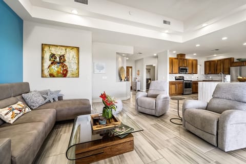 Sectional Sofa, Coffee Table, Armchairs, and the Kitchen