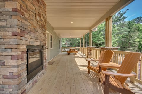 Wraparound Porch with Chairs and Fireplace outside "On The Rocks"