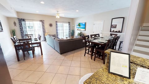 Bright open space with comfortable seating and a dining area perfect for gathering after a day at the beach.