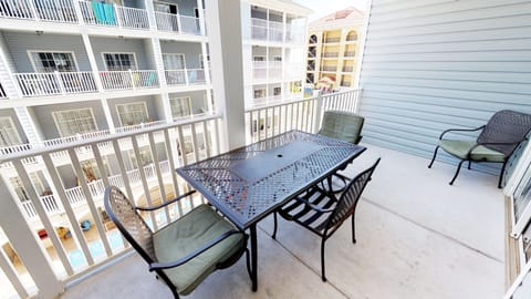 Enjoy the fresh coastal air from the private balcony with outdoor table seating.