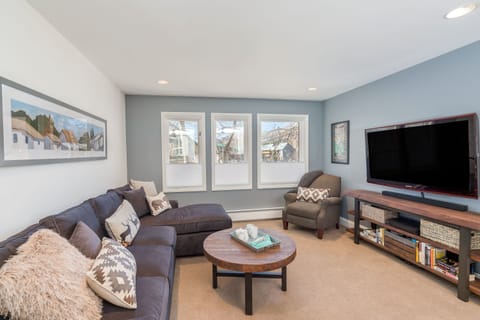 Living Room with Sectional Sofa, Armchair, and Smart TV