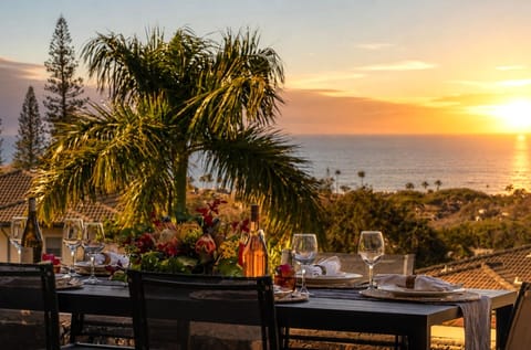 Gather for sunset drinks on the lanai with a spacious dining table and peaceful resort and ocean views.