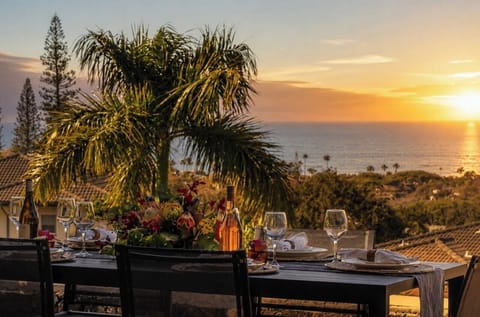 Gather for sunset drinks on the lanai with a spacious dining table and peaceful resort and ocean views.