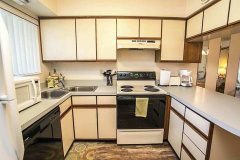 - Fully equipped kitchen with stove, microwave, and dishwasher for easy cooking
- Plenty of counter space makes it simple to prepare meals or enjoy morning coffee
- Neutral cabinetry and bright window create a clean and functional setup