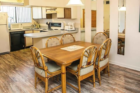 - Dining area with table and seating for six perfect for meals with family or friends
- Open design flows into the kitchen offering easy access for serving and dining
- Bright lighting and wood finishes give the space a casual welcoming style