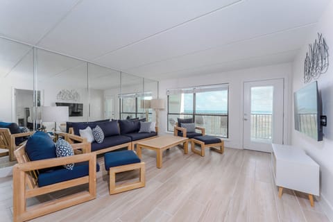 Our beachfront living room, illuminated by sunlight from the tall windows and mirrored wall, is the perfect setting for a sunny South Padre beach vacation!