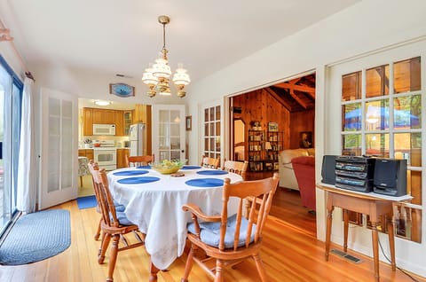 The dining room opens to the kitchen, living room, and back deck.