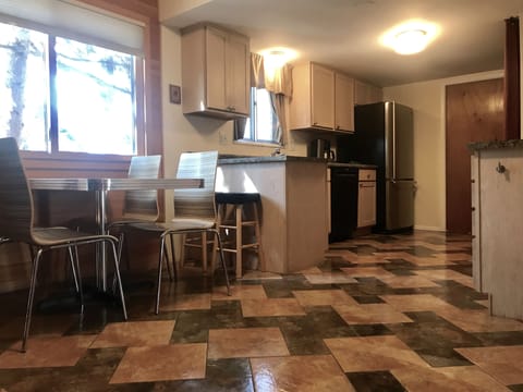 Eat-in kitchen table seats 4. Pocket door opens to formal dining/living rm area