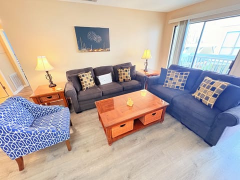 Sink into comfortable seating with coastal artwork and warm lighting creating your perfect retreat for relaxation.