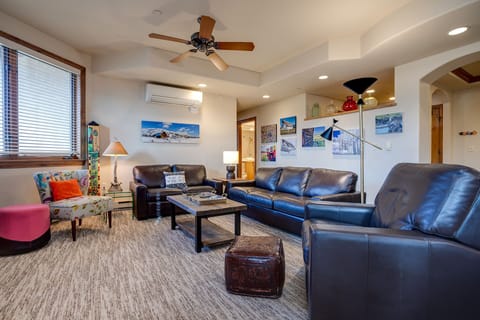 Sink into plush leather sofas in your spacious living room, where local artwork and warm lighting create the perfect atmosphere for relaxation.