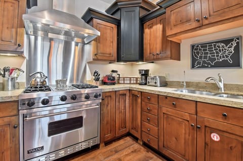 Your gourmet kitchen awaits with professional-grade Viking appliances, rich wood cabinetry, and granite countertops perfect for creating memorable meals.