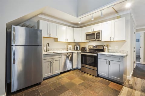 Fully equipped kitchen with slate flooring.