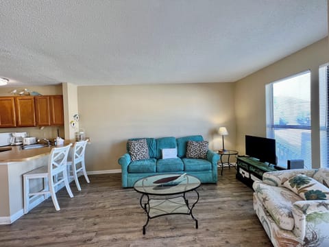 Unwind in your spacious open-concept living area with comfortable seating and modern amenities for memorable vacation moments.