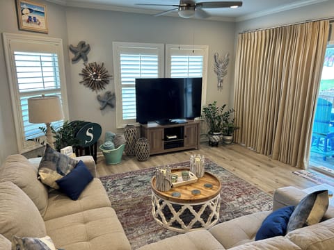 Sink into plush sectional seating in your coastal-themed living room, where beach-inspired décor and modern amenities create the perfect space to unwind.