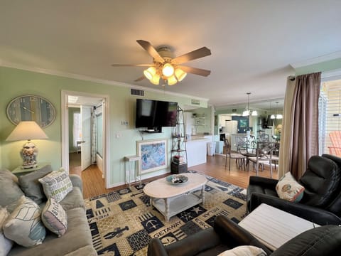 Relax in your spacious living room with plush seating, warm lighting, and open-concept flow to the kitchen.