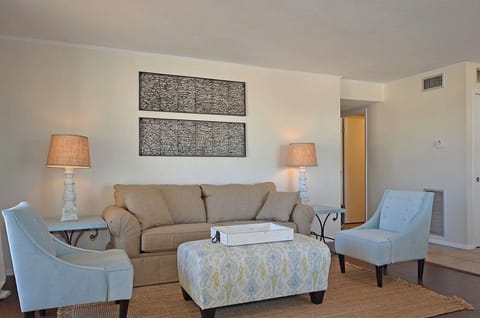 Unwind in your elegantly appointed living room, where soft lighting and comfortable seating create the perfect retreat for relaxation.