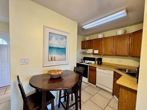 Your cozy kitchen features warm wood cabinets, full appliances, and a charming dining nook perfect for morning coffee or casual meals.