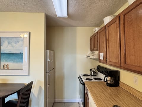 Your fully equipped kitchen features warm wood cabinetry, modern appliances, and everything you need to prepare meals during your stay.