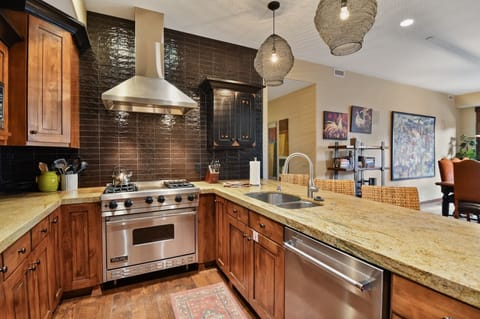 Your gourmet kitchen awaits with warm wood cabinetry, granite counters, and top-tier Viking appliances for memorable culinary moments.