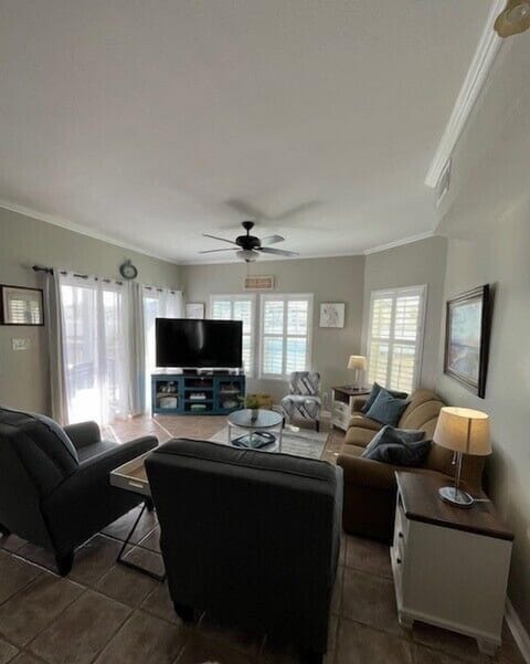 Your spacious living room offers the perfect gathering spot with cozy seating, entertainment center, and abundant natural light from multiple windows.