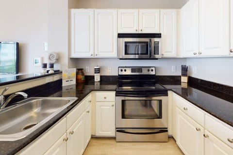 Fully equipped kitchen with granite counter-tops and stainless appliances