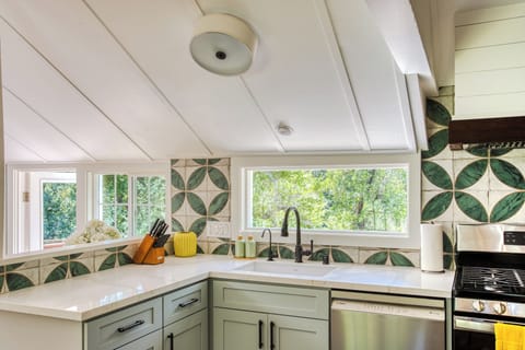 Big window over sink, looking over woodlands.