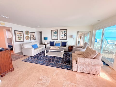 Sink into plush seating and soak up stunning ocean views through your private sliding doors in this bright, elegantly furnished living space.