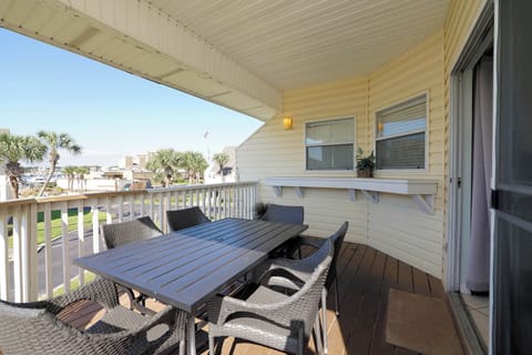 Your private covered balcony offers peaceful dining with wicker seating, perfect for morning coffee or evening meals overlooking the neighborhood.